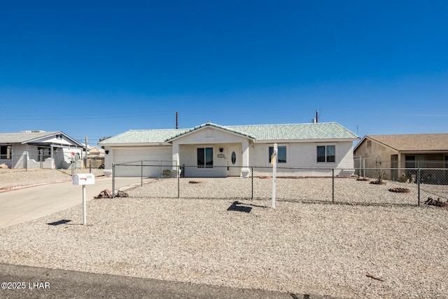 view of front of home featuring concrete driveway, fence private yard, a garage, and stucco siding