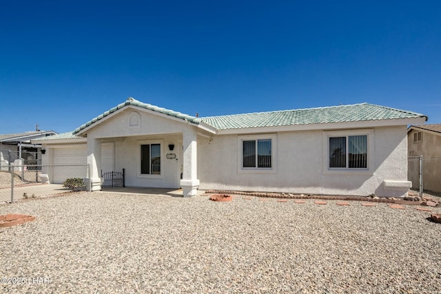 single story home featuring stucco siding, a garage, a tile roof, and fence