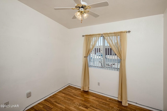 spare room featuring a ceiling fan and wood finished floors