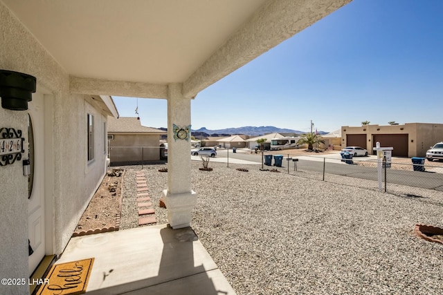 view of yard with a mountain view, a residential view, and fence