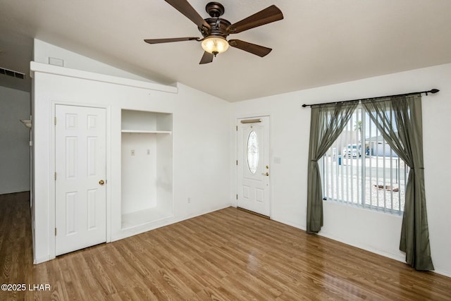 foyer entrance featuring visible vents, wood finished floors, ceiling fan, and vaulted ceiling