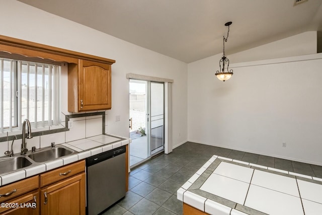 kitchen featuring tile countertops, a sink, vaulted ceiling, stainless steel dishwasher, and dark tile patterned floors