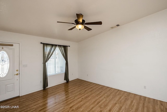 entryway with visible vents, a ceiling fan, and wood finished floors