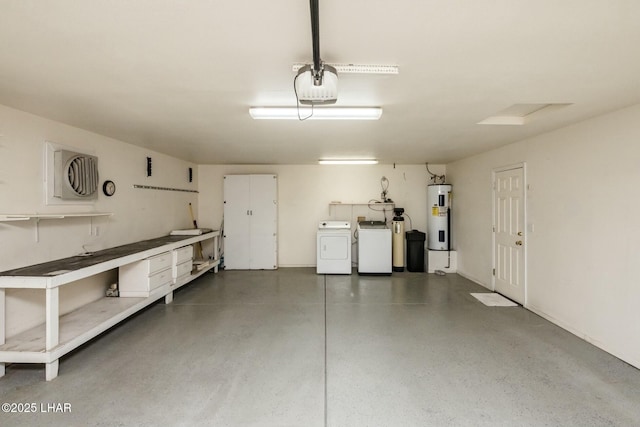 garage with a garage door opener, water heater, and washing machine and clothes dryer