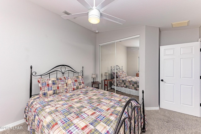 carpeted bedroom featuring ceiling fan and a closet