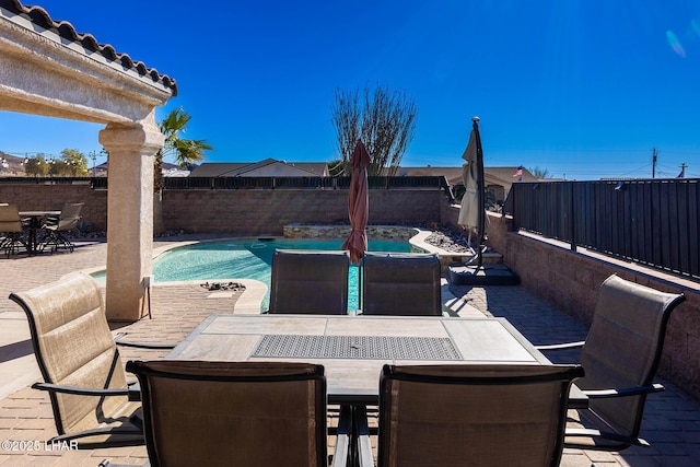 view of patio with a swimming pool with hot tub