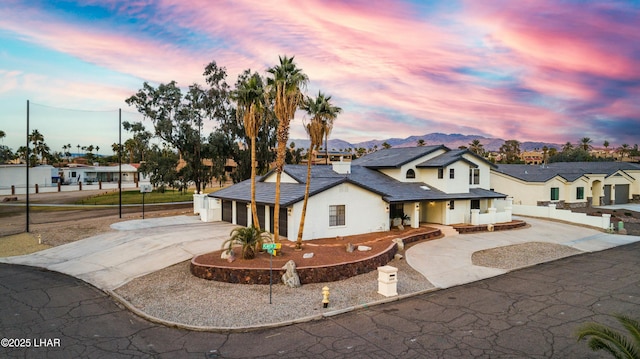 view of front facade featuring a mountain view and a garage