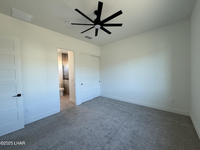 unfurnished bedroom with carpet floors, a closet, ceiling fan, and ensuite bathroom