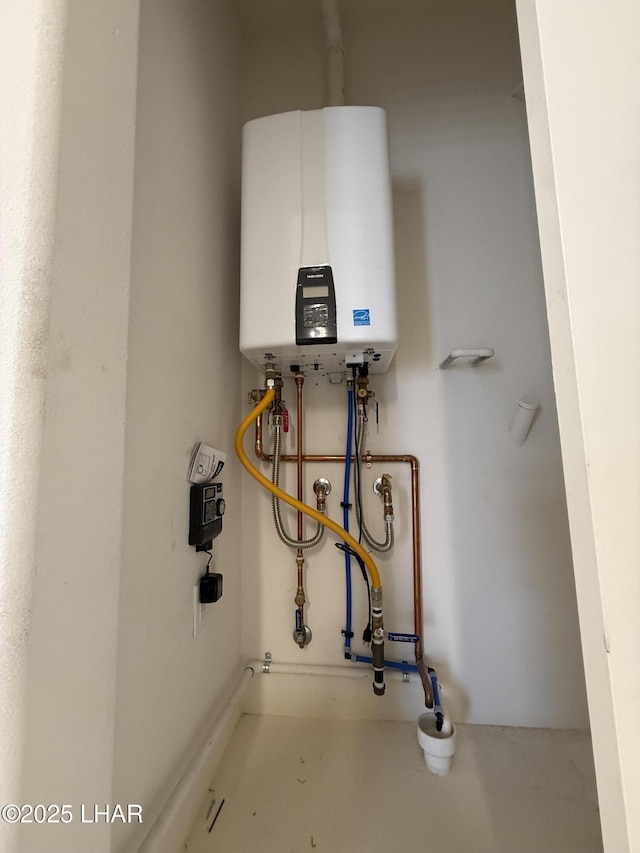 utility room featuring tankless water heater