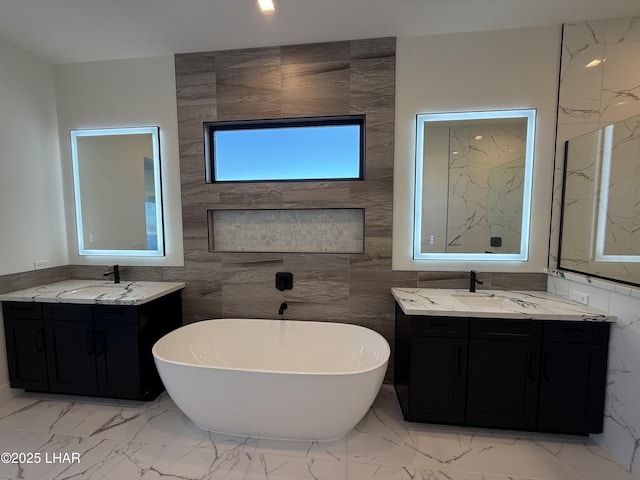 bathroom featuring vanity, a washtub, and tile walls