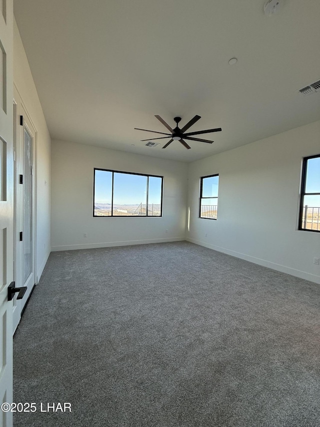 carpeted spare room with ceiling fan