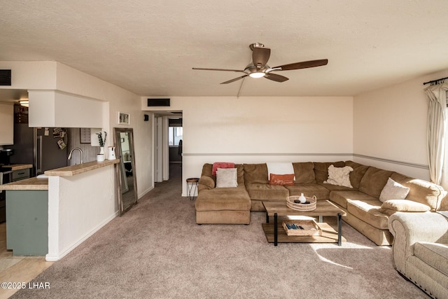 1824 Montana Vis Unit D, Lake Havasu City, AZ 86403 - living area with light carpet, baseboards, a ceiling fan, and visible vents