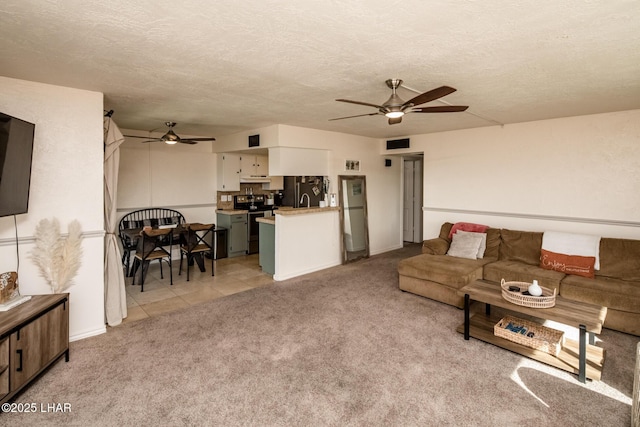 1824 Montana Vis Unit D, Lake Havasu City, AZ 86403 - living area featuring a textured ceiling, visible vents, ceiling fan, light carpet, and light tile patterned floors