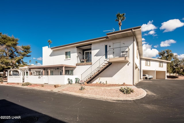 1824 Montana Vis Unit D, Lake Havasu City, AZ 86403 - view of front facade with an attached garage, stucco siding, driveway, and stairs