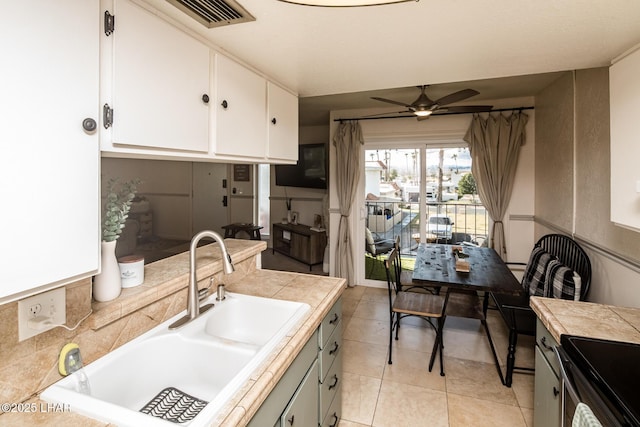 1824 Montana Vis Unit D, Lake Havasu City, AZ 86403 - kitchen featuring light tile patterned floors, a ceiling fan, a sink, white cabinetry, and visible vents