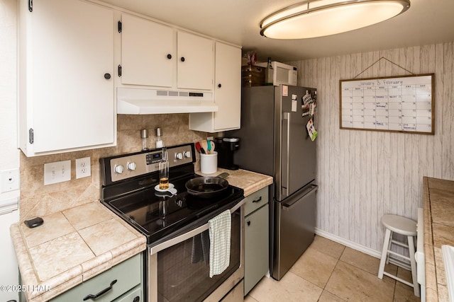 1824 Montana Vis Unit D, Lake Havasu City, AZ 86403 - kitchen with tile counters, white cabinets, backsplash, under cabinet range hood, and appliances with stainless steel finishes