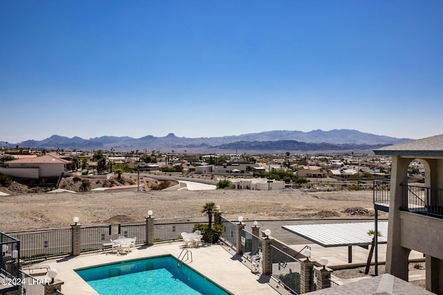 view of pool with a mountain view and a patio area