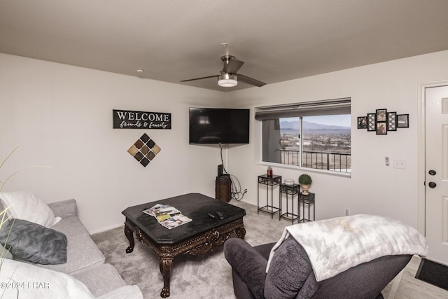 living room with light colored carpet and ceiling fan