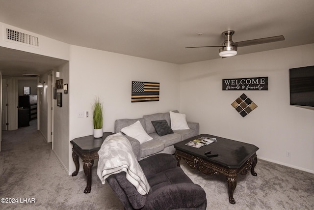 carpeted living room with ceiling fan