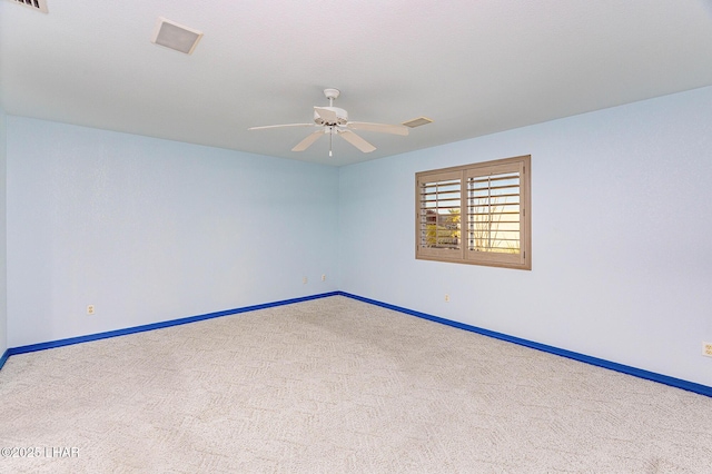 empty room with a ceiling fan, carpet, visible vents, and baseboards