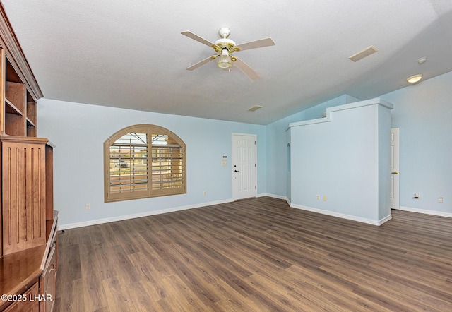 unfurnished living room featuring baseboards, vaulted ceiling, dark wood-style floors, and a ceiling fan