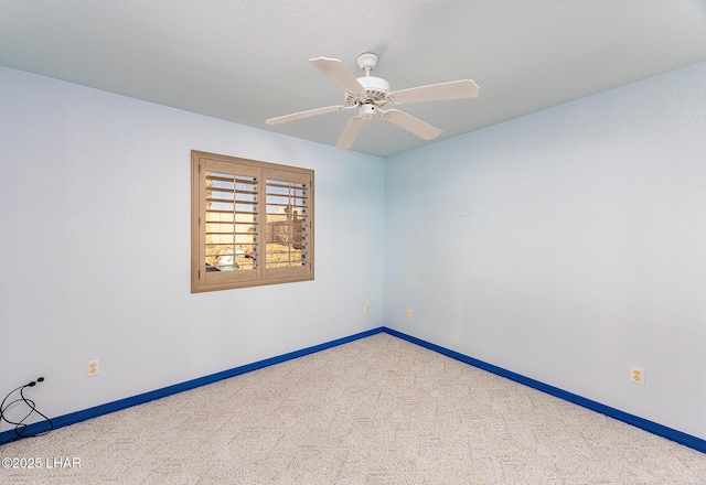 spare room with ceiling fan, a textured ceiling, baseboards, and carpet flooring