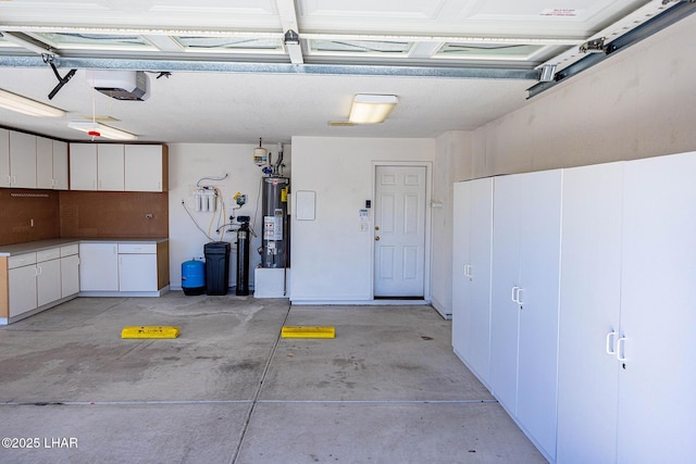 garage featuring water heater and a garage door opener