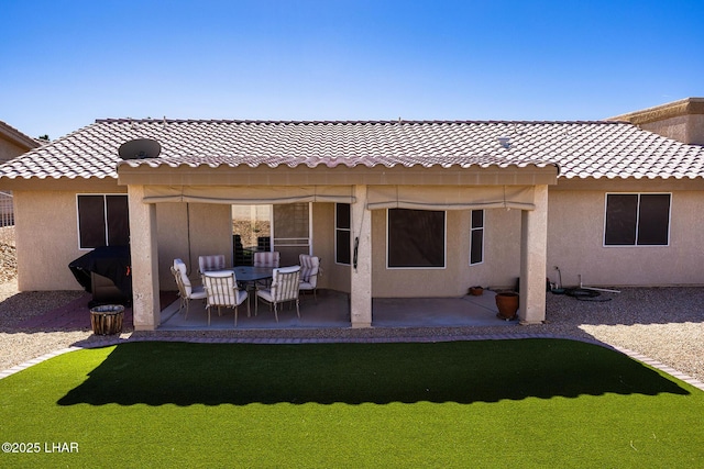 back of property with a patio area, a tile roof, and stucco siding