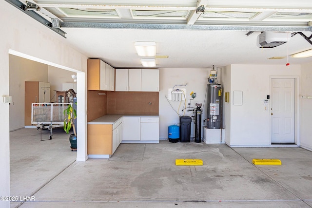 garage with water heater and a garage door opener