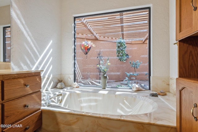 interior details featuring a textured wall and a bathtub