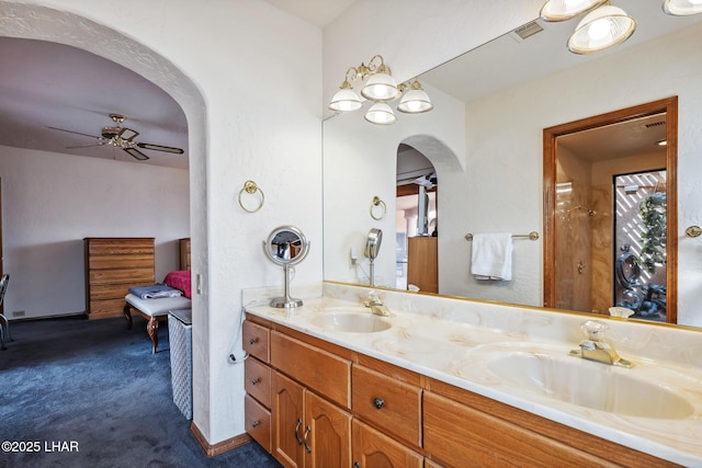 bathroom featuring double vanity, visible vents, a sink, and ceiling fan