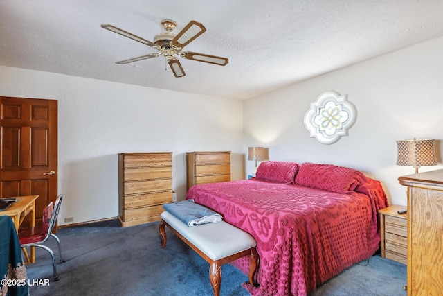 bedroom with a ceiling fan, carpet, and a textured ceiling