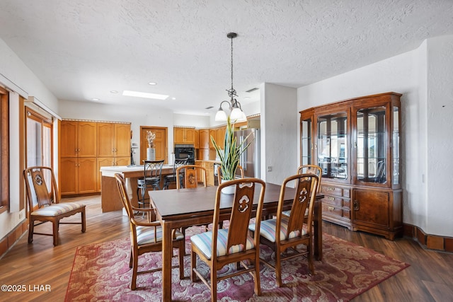 dining area featuring plenty of natural light, baseboards, and wood finished floors