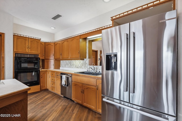 kitchen featuring visible vents, light countertops, appliances with stainless steel finishes, tasteful backsplash, and dark wood finished floors