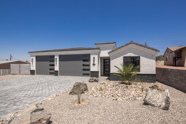 2185 Palo Verde Blvd S, Lake Havasu City, AZ 86403 - view of front facade featuring a garage, decorative driveway, stucco siding, and a tile roof