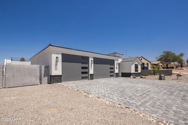 2185 Palo Verde Blvd S, Lake Havasu City, AZ 86403 - view of front facade with stucco siding, a garage, decorative driveway, and stone siding