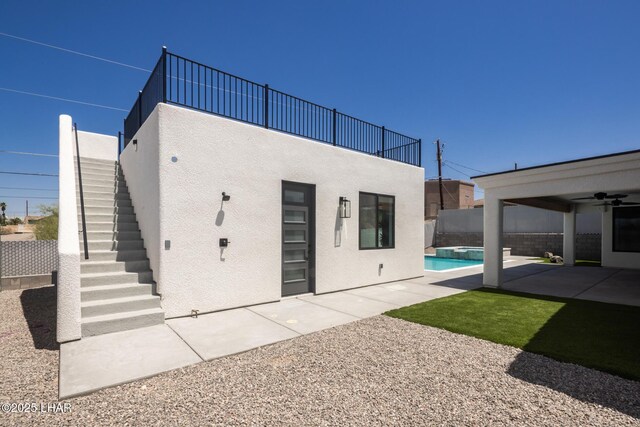 2185 Palo Verde Blvd S, Lake Havasu City, AZ 86403 - rear view of property featuring stucco siding, a pool with connected hot tub, a patio area, ceiling fan, and stairway
