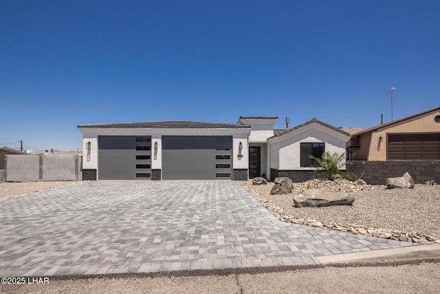 2185 Palo Verde Blvd S, Lake Havasu City, AZ 86403 - view of front of property with decorative driveway, stucco siding, an attached garage, and stone siding