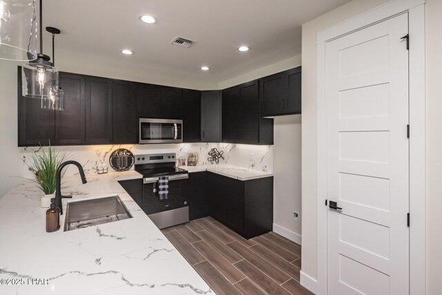 2185 Palo Verde Blvd S, Lake Havasu City, AZ 86403 - kitchen featuring stainless steel appliances, light stone counters, recessed lighting, dark cabinets, and dark wood-style floors