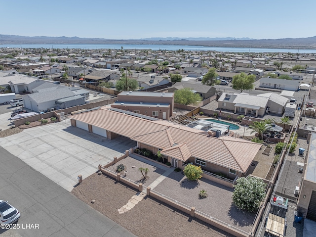 drone / aerial view featuring a water and mountain view