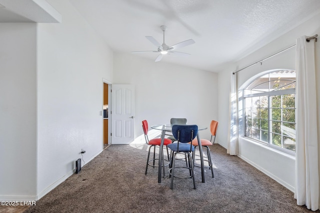 dining space with a wealth of natural light, baseboards, vaulted ceiling, and carpet flooring