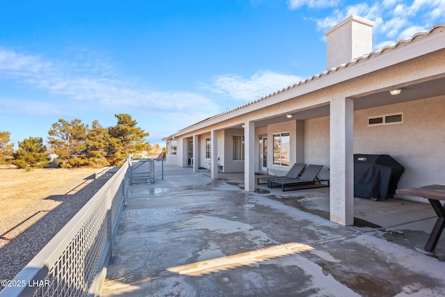 view of patio with grilling area and a balcony