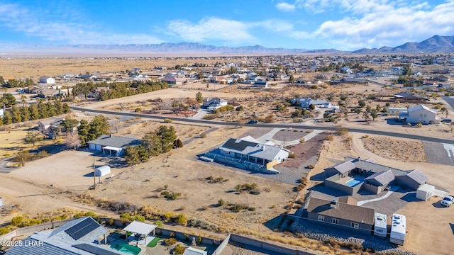 aerial view featuring a desert view and a mountain view