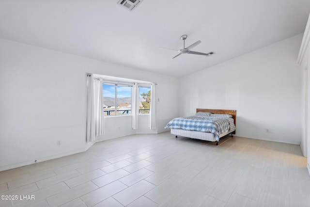 bedroom with lofted ceiling, visible vents, and a ceiling fan