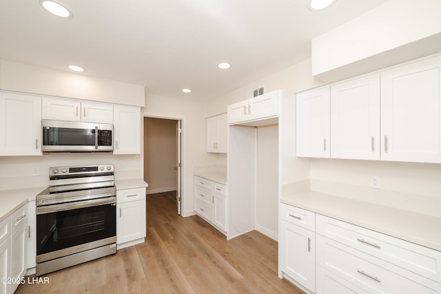 2529 Sunchief Ln, Lake Havasu City, AZ 86403 - kitchen with appliances with stainless steel finishes, white cabinetry, light countertops, and recessed lighting