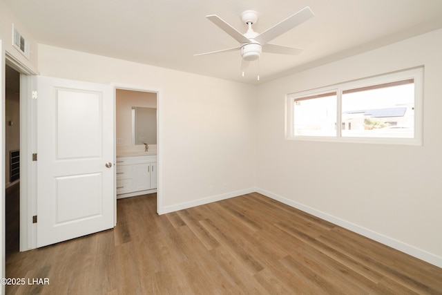 2529 Sunchief Ln, Lake Havasu City, AZ 86403 - unfurnished bedroom with light wood-type flooring, baseboards, and connected bathroom