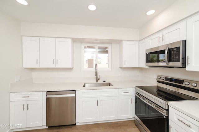 2529 Sunchief Ln, Lake Havasu City, AZ 86403 - kitchen with appliances with stainless steel finishes, a sink, white cabinets, light countertops, and recessed lighting
