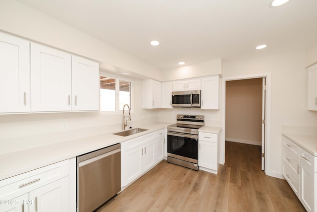 2529 Sunchief Ln, Lake Havasu City, AZ 86403 - kitchen with appliances with stainless steel finishes, a sink, white cabinets, recessed lighting, and light countertops