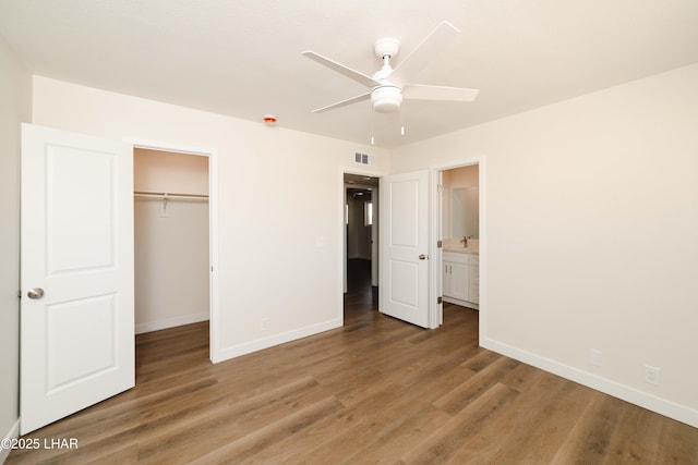 2529 Sunchief Ln, Lake Havasu City, AZ 86403 - unfurnished bedroom featuring baseboards, light wood-type flooring, a closet, and a spacious closet