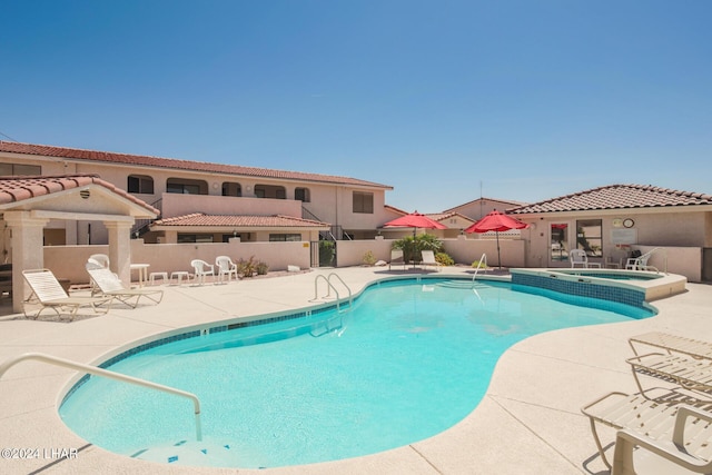 view of pool with a community hot tub and a patio